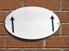 Oval displays with white arrows on a red brick