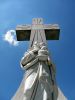 Cross and statue isolated on blue sky