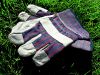 Work or construction gloves isolated on green grass