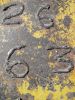 Number on a yellow rusty metal 