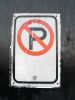 Sign prohibits parking, no parking on black plate