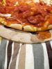 Pizza homemade on four color kitchen glove  